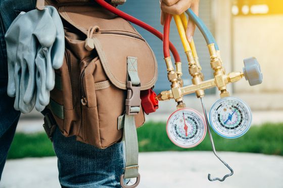 HVAC technician with manifold gauges